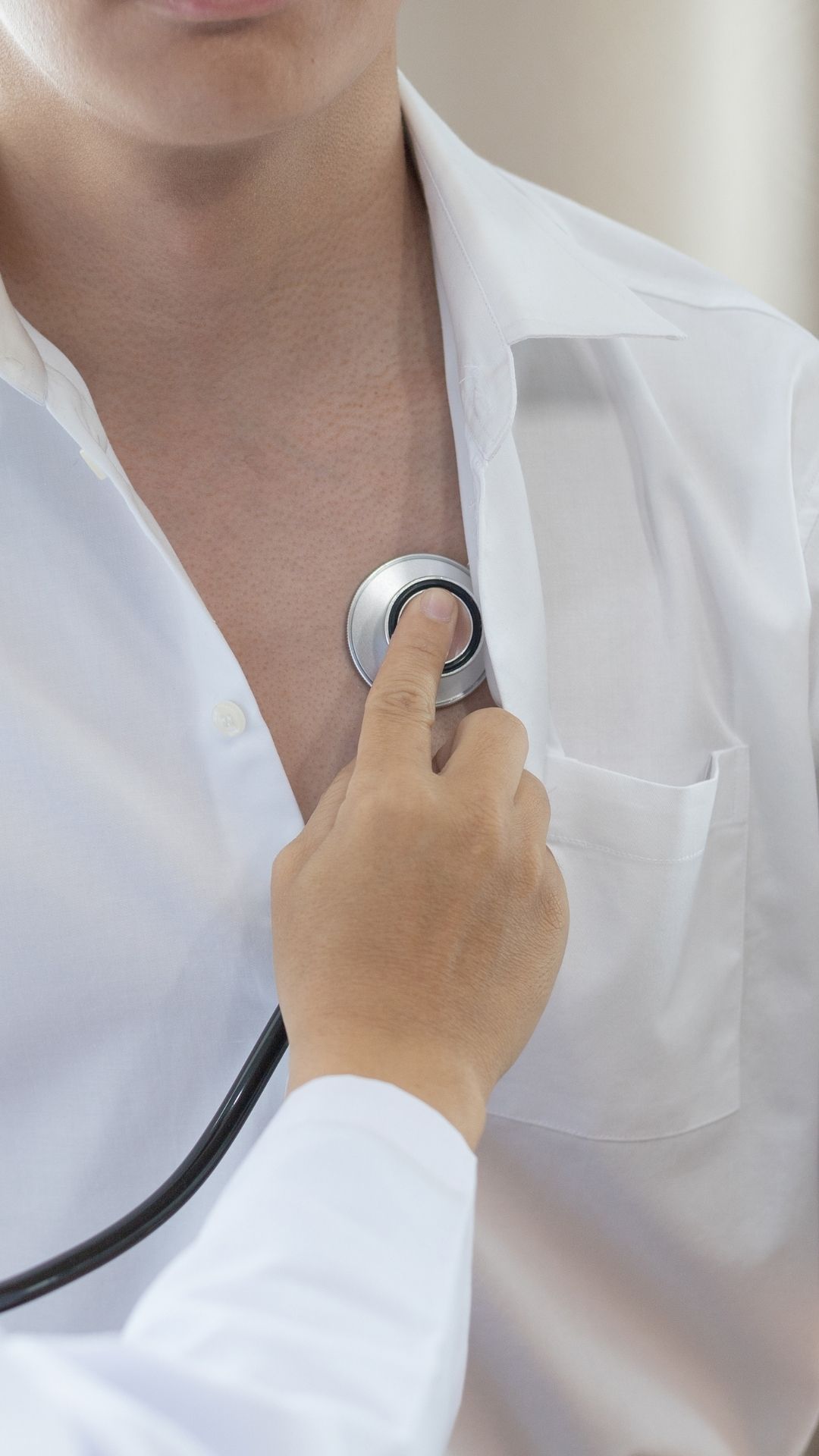Close-up of a stethoscope placed on a person’s chest during a medical check-up.