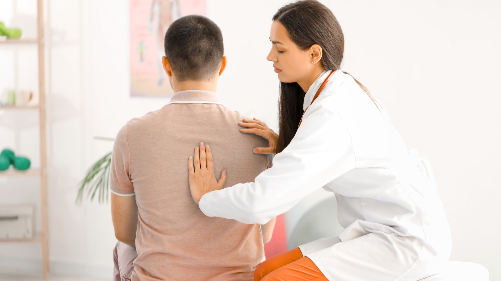 Movement and posture screening and correction Healthcare professional palpating a seated patient’s back during a medical exam in a clinical setting.
