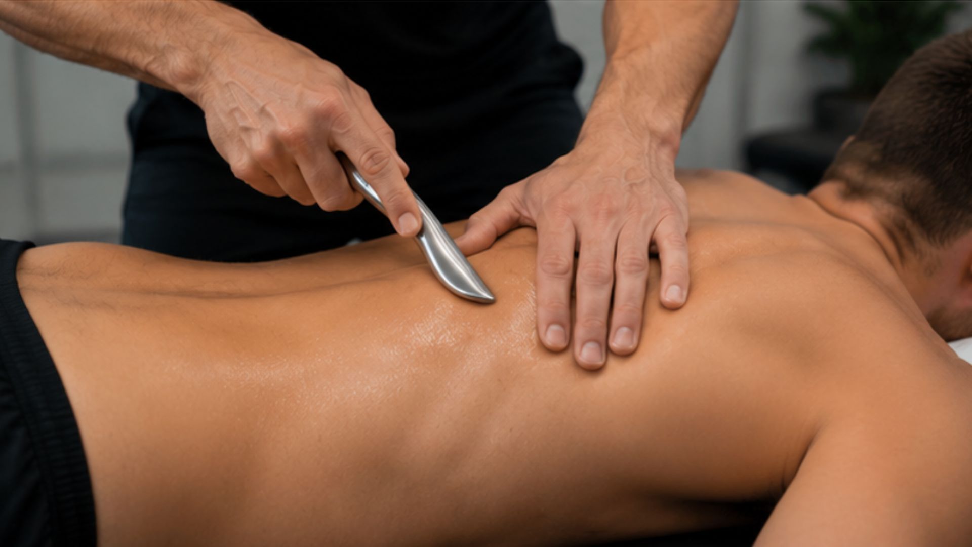 G3 A person receives a physical therapy session with a metal tool being applied to their back. The setting is calm, focusing on muscle relief and treatment.