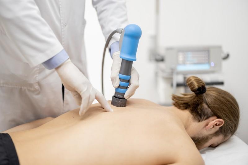 doctor-applies-shock-wave-therapy-mens-shoulder_28698134