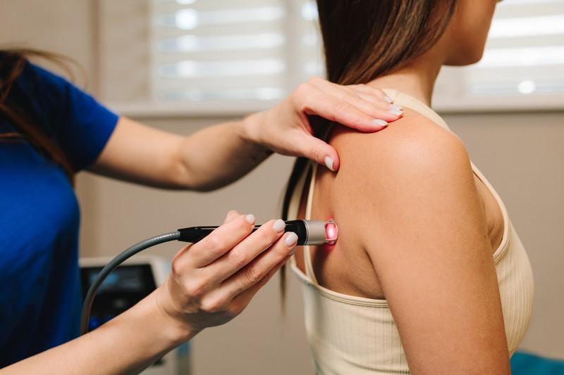 laser-therapy-chronic-back-pain-effective-laser-therapy-restore-damaged-muscle-tissues-nerves-woman-is-healing-with-red-light-reduce-pain-inflammation-edemas-her-back_358039289