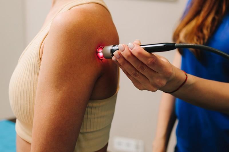 laser-therapy-chronic-back-pain-woman-is-healing-with-red-light-reduce-pain-inflammation-edemas-her-back-effective-laser-therapy-restore-damaged-muscle-tissues-nerves_374424051
