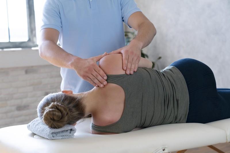 physiotherapist-massaging-patient-close-up_16601991