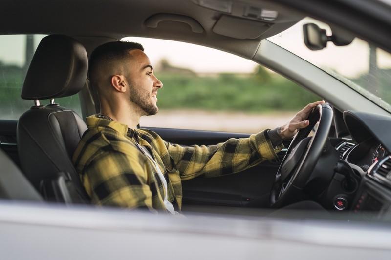 shallow-focus-shot-handsome-spanish-caucasian-man-sitting-wheel-modern-car_30561271