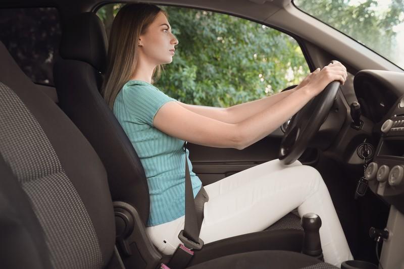 young-woman-with-fastened-safety-belt-driver-s-seat-car_37689324