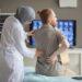 rear-view-male-patient-complaining-back-pain-female-doctor-examining-him-medical-exam-hospital_12466234.jpg