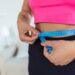 weight-loss-concept-portrait-millennial-african-american-lady-top-bra-leggings-measuring-her-waist-using-blue-tape-free-copy-space-black-woman-checking-body-parameters_28859699.jpg